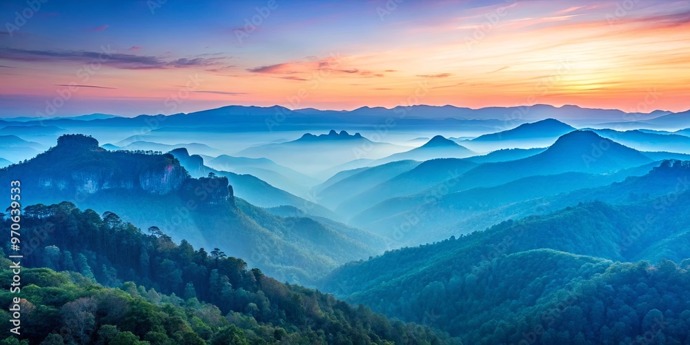 Tranquil blue mountains under a soft pastel dawn sky Tranquil blue mountains under a soft pastel dawn sky
