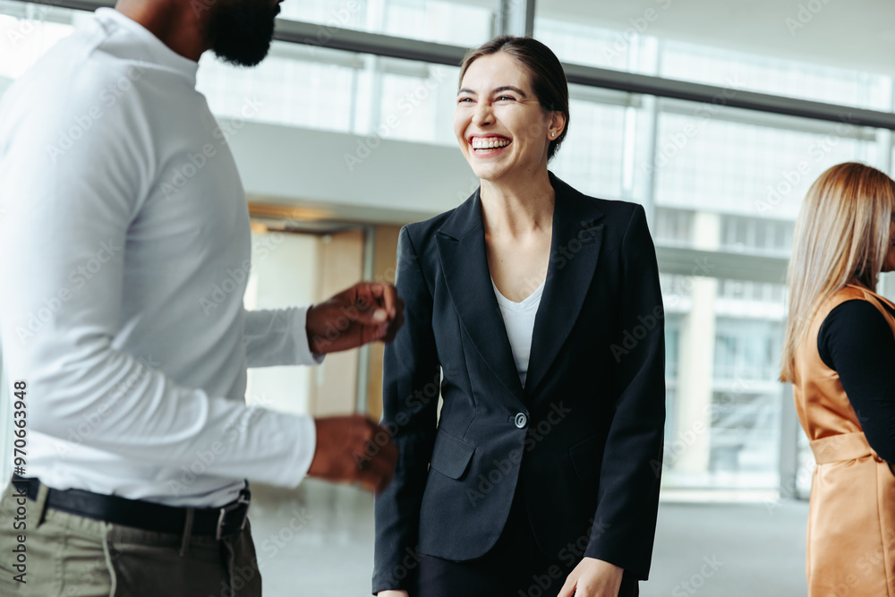Businesswoman laughing and networking at a conference in an office setting Businesswoman laughing and networking at a conference in an office setting