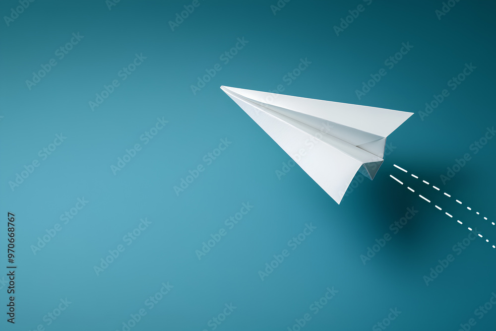 A paper airplane soaring against a turquoise background, symbolizing creativity and freedom. A paper airplane soaring against a turquoise background, symbolizing creativity and freedom.
