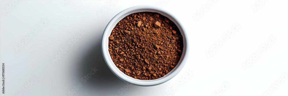Photo of Cocoa Powder in a White Bowl on a White Background Photo of Cocoa Powder in a White Bowl on a White Background
