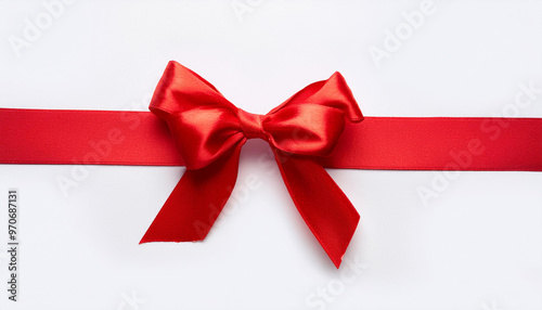 Red satin ribbon with bow on white background, top view