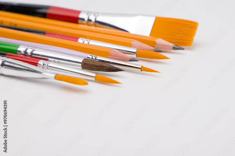 Pencils and brushes for drawing of different sizes. Close up view. Pencils and brushes for drawing of different sizes. Close up view.