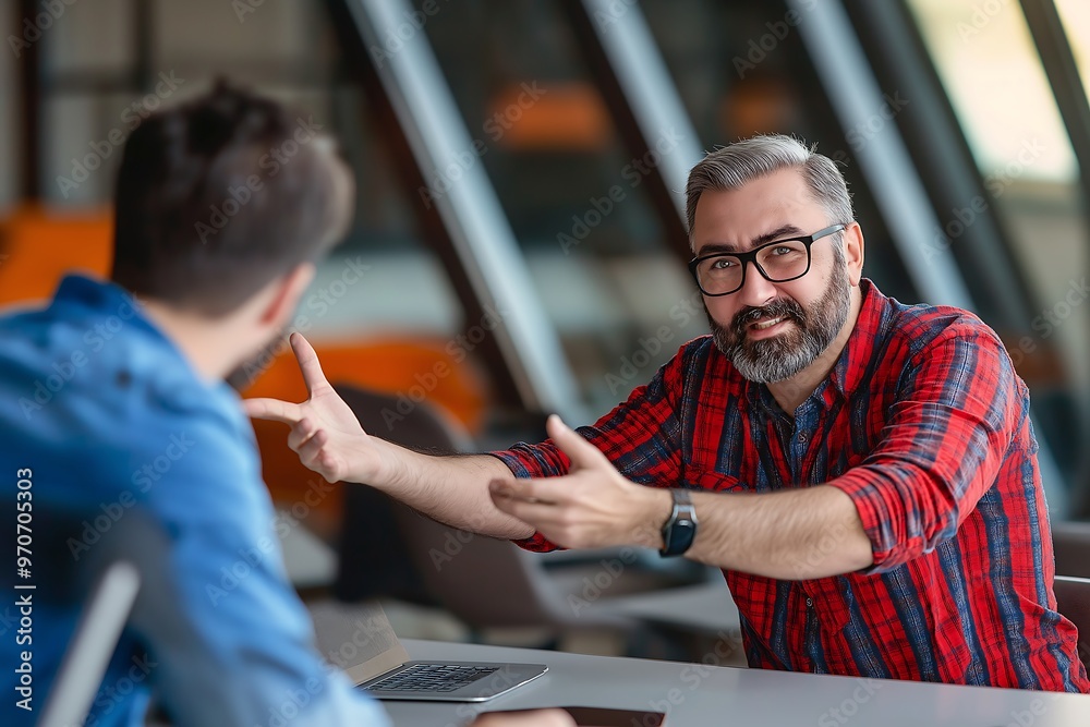 Senior businessman discussing and explaining colleague at table in office Senior businessman discussing and explaining colleague at table in office