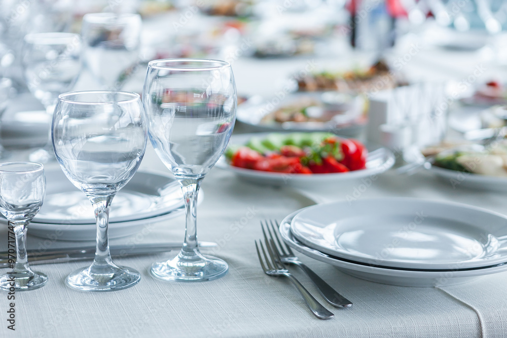 served table, glasses, plates, vase with forge served table, glasses, plates, vase with forge