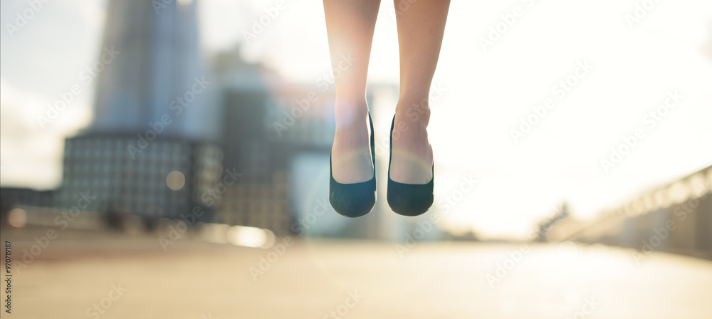 Feet, woman and floating in air on bridge for celebration, success and achievement with lens flare. Business person, foot and legs in closeup in city for victory, ascend and good news as prize winner
