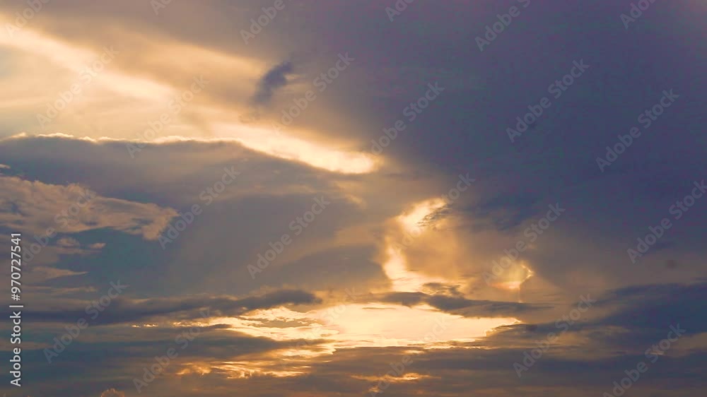 A timelapse video of an evening sky with beautiful clouds during the sunset making a golden light pattern in the clouds. 4K A timelapse video of an evening sky with beautiful clouds during the sunset making a golden light pattern in the clouds. 4K