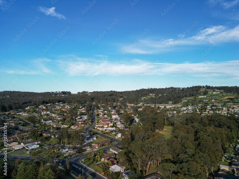 Obraz premium Aerial view of suburban neighborhood surrounded by greenery.