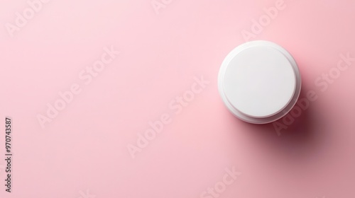 Flatlay of a single cosmetic jar on a pastel pink background, minimalist style, top view, soft lighting