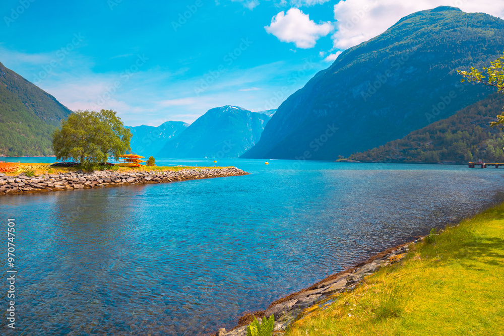 Obraz premium View of Geirangerfjord on a sunny day. Beautiful embankment of Hellesylt cruise port, Norway