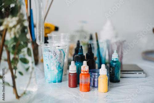 Creating vibrant epoxy resin art with various pigments and tools in a DIY workspace