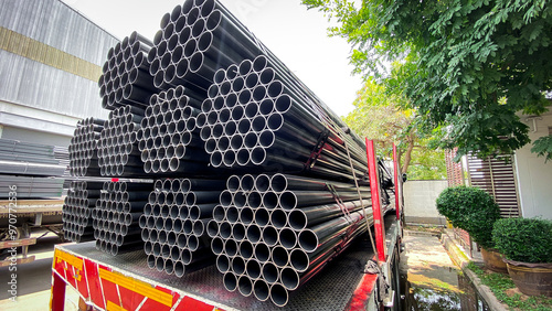 Construction products on transport vehicles Group of steel pipes for industrial materials Construction engineering products  equipment, steel pipes, metal warehouse industry, delivery to customers