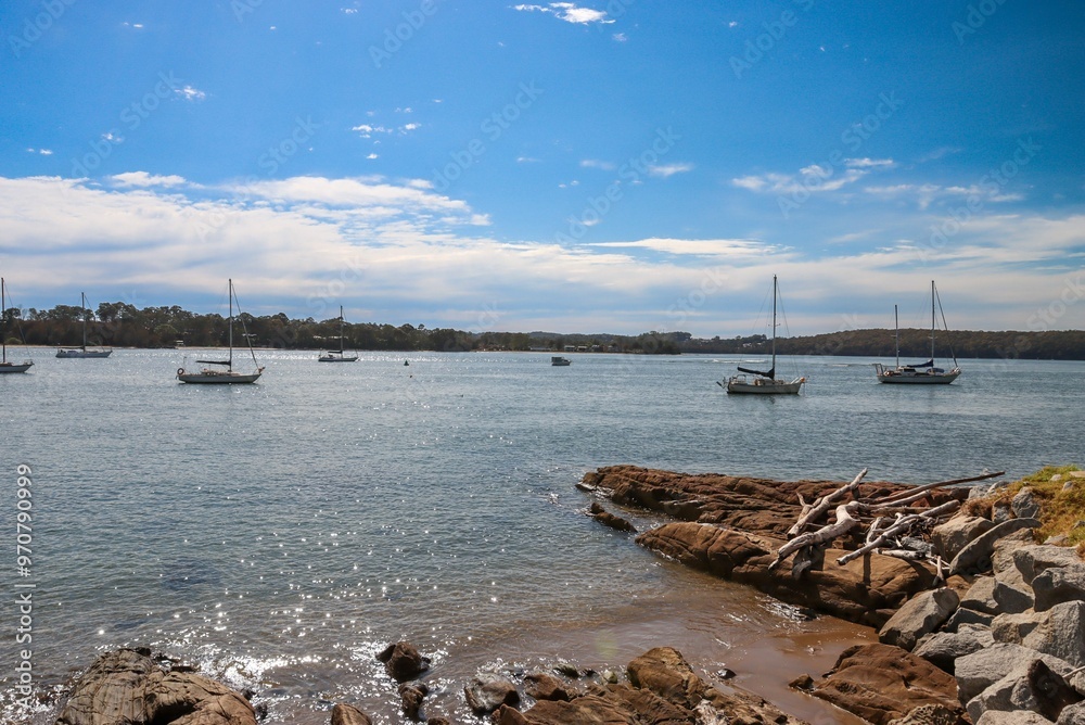 Serene coastal scene with anchored sailboats Serene coastal scene with anchored sailboats