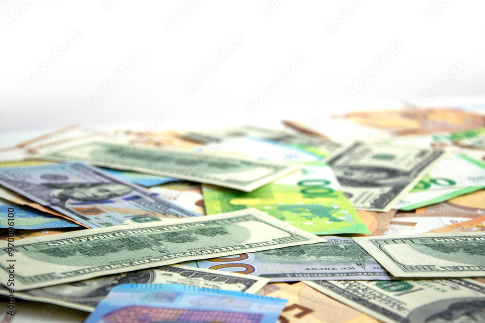 A close up image of a pile of US dollar and euro banknotes scattered on a white surface A close up image of a pile of US dollar and euro banknotes scattered on a white surface