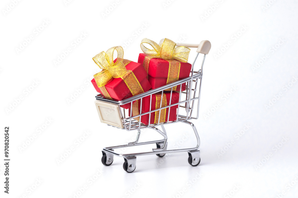 Supermarket trolley, cart with red gifts with gold bows, shopping isolated on white background. Discounts, Sale, Black Friday. Supermarket trolley, cart with red gifts with gold bows, shopping isolated on white background. Discounts, Sale, Black Friday.