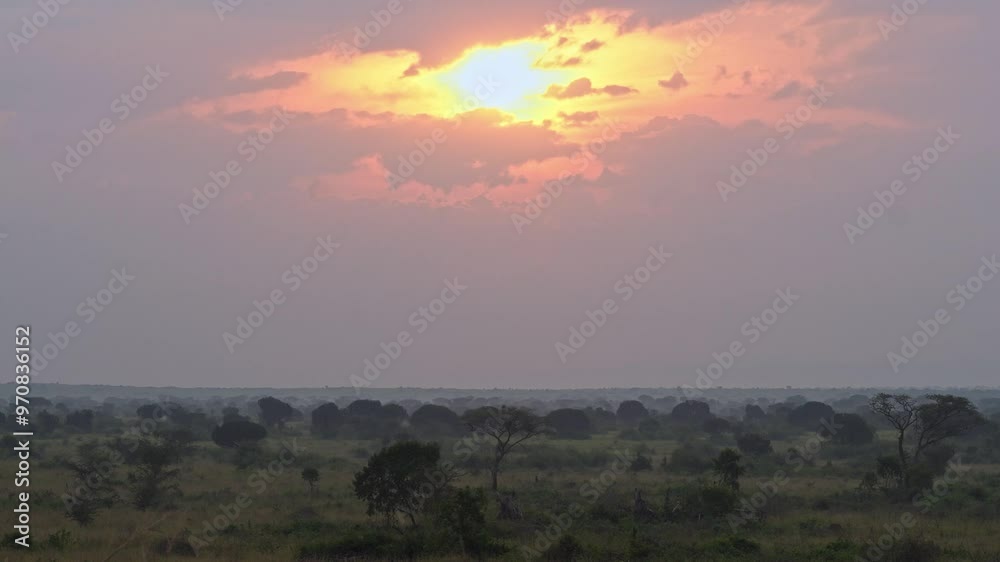 A serene landscape with sunlight through clouds, African Sunset in Uganda A serene landscape with sunlight through clouds, African Sunset in Uganda
