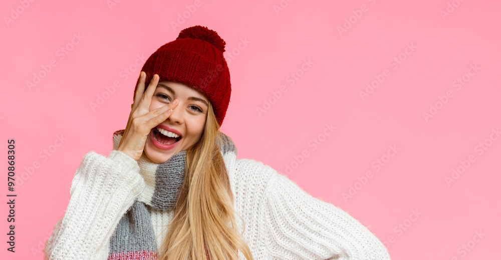 Joyful blonde girl in red hat placing fingers on her face, yellow studio background, panorama with copy space Joyful blonde girl in red hat placing fingers on her face, yellow studio background, panorama with copy space