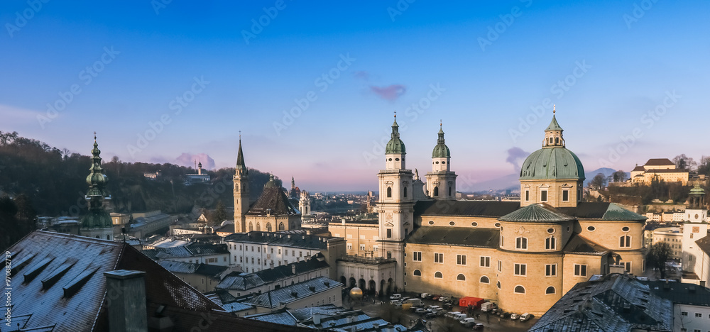 Fototapeta premium Winter morning in Salzburg showcasing historic architecture and scenic winter landscape under clear skies