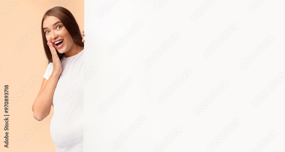 Great Offer. Excited Pregnant Girl Peeking Out Of Blank White Poster Standing Over Gray Studio Background, Mockup, Copy Space Great Offer. Excited Pregnant Girl Peeking Out Of Blank White Poster Standing Over Gray Studio Background, Mockup, Copy Space