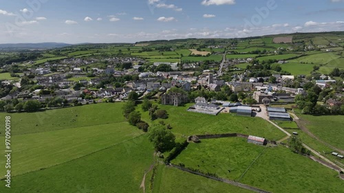 Raphoe Castle, County Donegal, Ireland, June 2023. Drone slowly orbits counter clockwise around the Bishop's Palace with the town in the background surrounded by green fields on a bright sunny day. photo