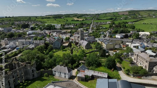 Raphoe Castle, County Donegal, Ireland, June 2023. Drone orbits clockwise tracking left from St Eunan's Cathedral and the town revealing the Bishop's Palace ruins on a warm sunny afternoon. photo