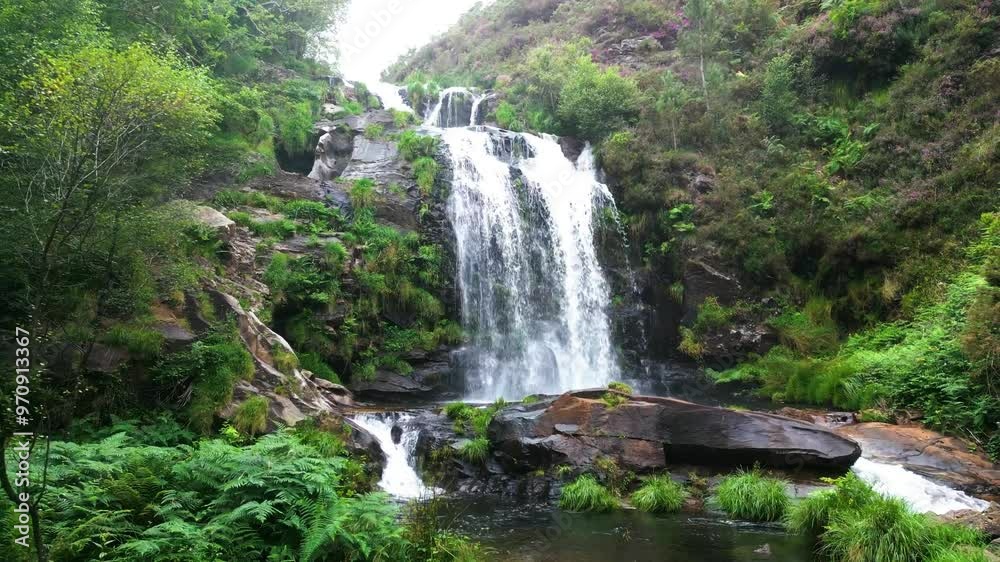 Beautiful waterfall in the middle of the jungle during a cloudy day Beautiful waterfall in the middle of the jungle during a cloudy day
