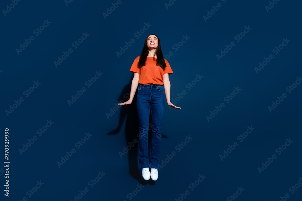 Photo of crazy cheerful woman wear trendy clothes look up empty space poster isolated on dark blue color background Photo of crazy cheerful woman wear trendy clothes look up empty space poster isolated on dark blue color background