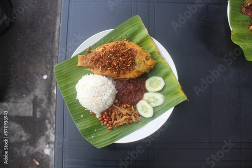 Nasi Lemak berlauk ikan Talapia. Coconut rice with fried Talapia fish and spicy sambal included. malaysia meal.