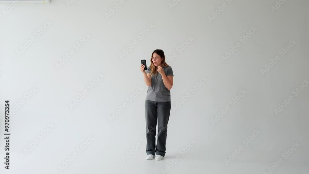 Friendly Caucasian young adult woman talking with friends on video call with phone on white background. Concept of an online communication and digital connection.