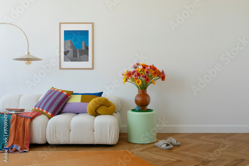 Stylish sofa setup with bold cushions and fresh flowers, creating a cheerful and inviting atmosphere. Mock up poster frame. photo