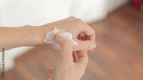 A woman's hand with a burn scar. A woman touches her hand with a skin lesion.