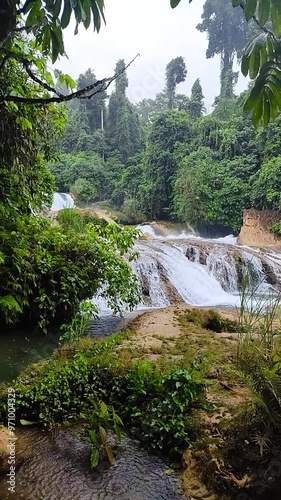 Aliwagwag Falls with small drops of rain. Mindanao, Philippines. Vertical view. photo