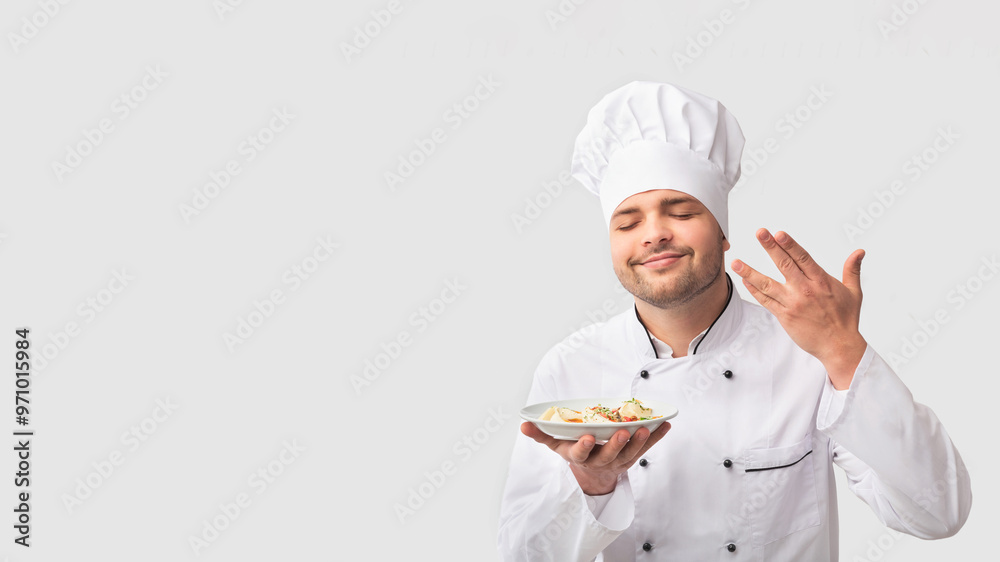 Cooking Food. Chef Man Holding Plate Smelling The Aroma Of Dish Standing Over White Studio Background. Panorama Cooking Food. Chef Man Holding Plate Smelling The Aroma Of Dish Standing Over White Studio Background. Panorama