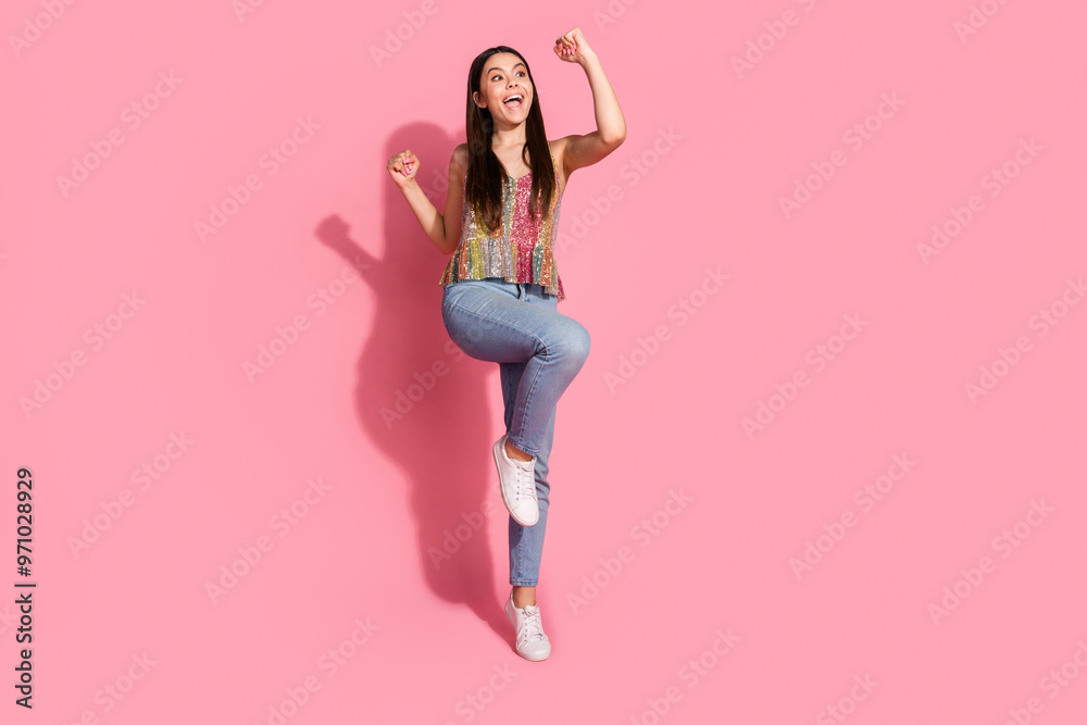 Full length photo of shiny lucky lady dressed singlet rising fists empty space isolated pink color background Full length photo of shiny lucky lady dressed singlet rising fists empty space isolated pink color background
