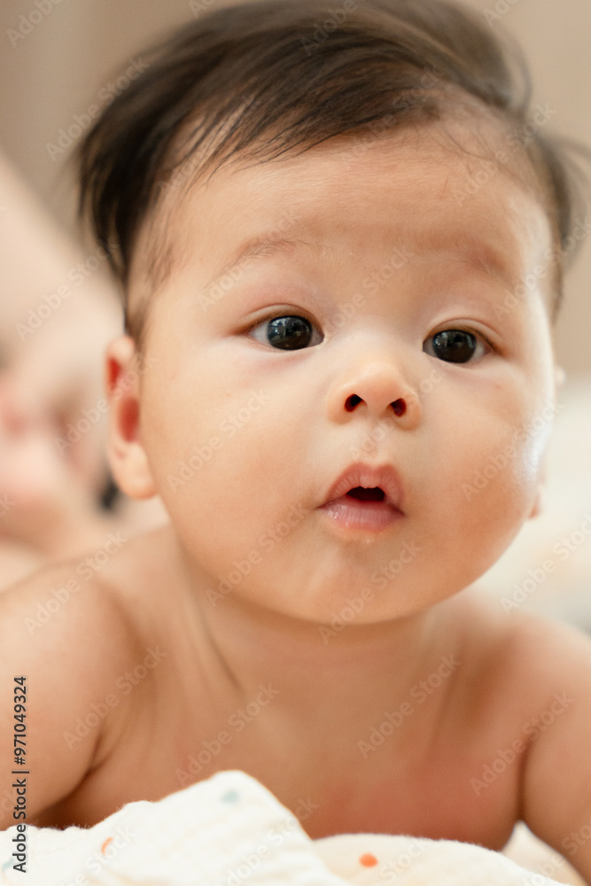 a close up of a baby looking at the camera a close up of a baby looking at the camera