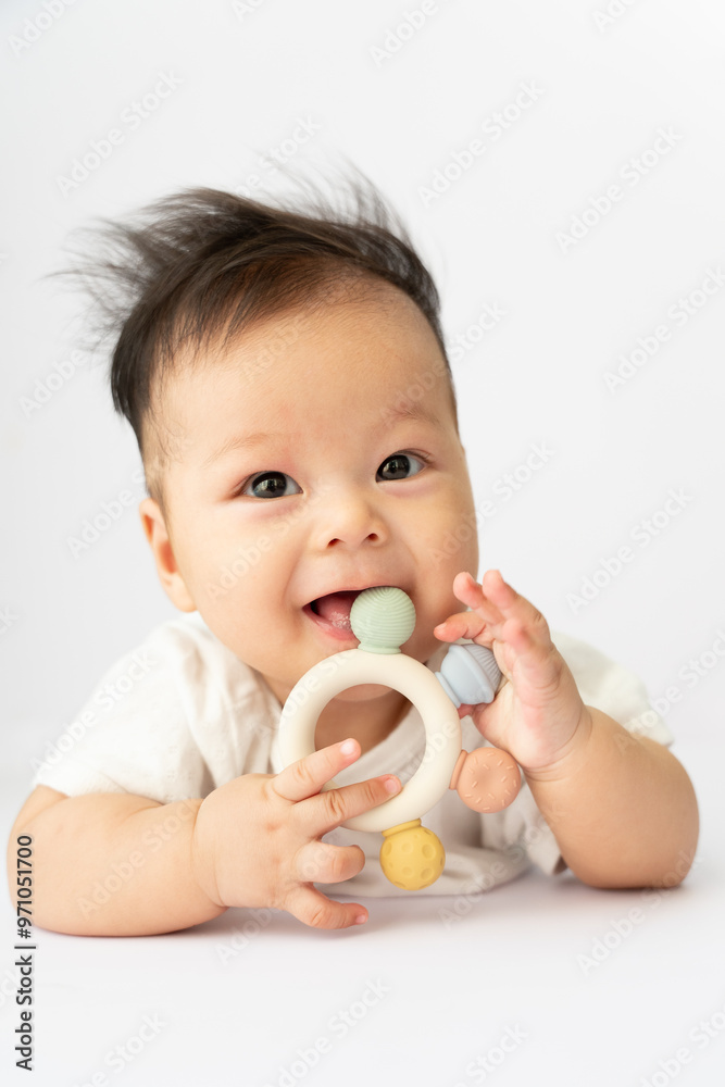 a baby is playing with a toy on a white surface a baby is playing with a toy on a white surface