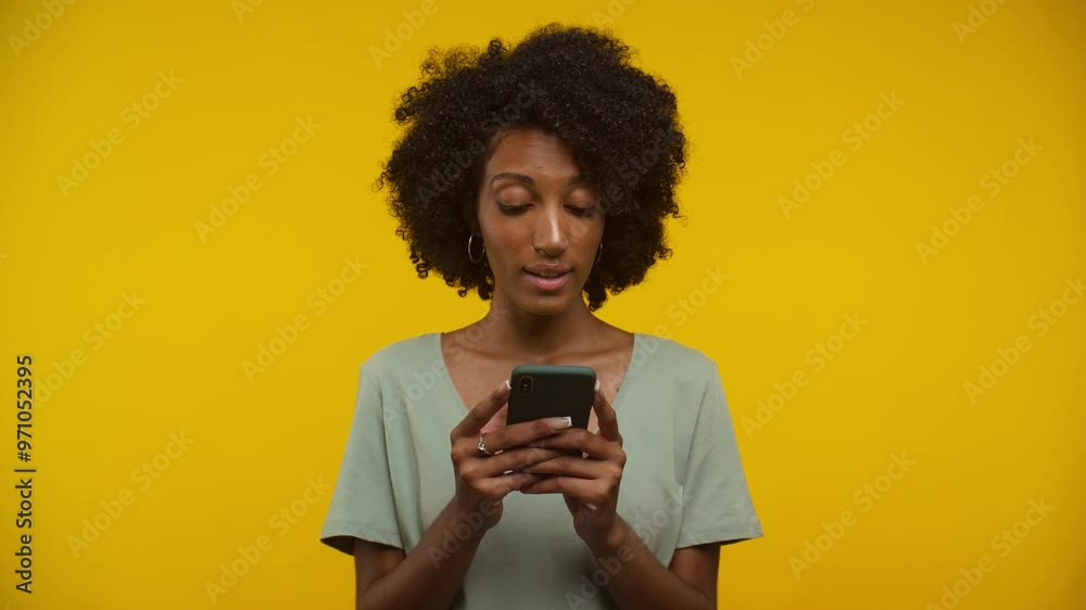 Smiling woman using smartphone against yellow background Smiling woman using smartphone against yellow background