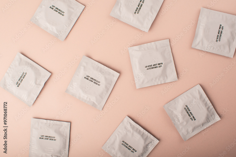 Condoms background pink. Pattern from mens contraception. Sexually transmitted diseases infections protection. Concept of birth control. Safe sex. STD. View from above. High quality photo Condoms background pink. Pattern from mens contraception. Sexually transmitted diseases infections protection. Concept of birth control. Safe sex. STD. View from above. High quality photo