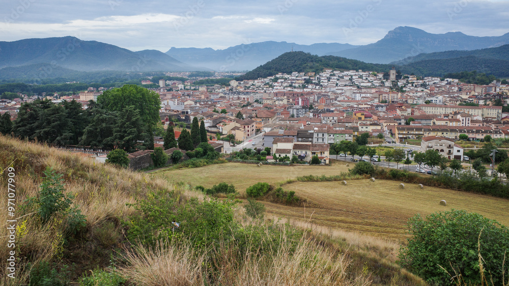 Naklejka premium Olot, Spain - 7 Aug, 2024: View from Montsacopa Volcano over the town of Olot, Garrotxa, Catalonia