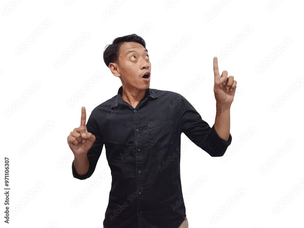 Shocked young Asian man in casual shirt pointing finger aside at copy space isolated on white background. Great offer concept Shocked young Asian man in casual shirt pointing finger aside at copy space isolated on white background. Great offer concept