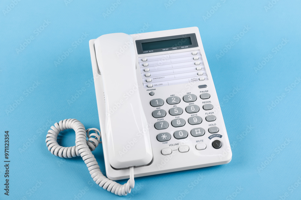 White telephone with handset on light blue background White telephone with handset on light blue background