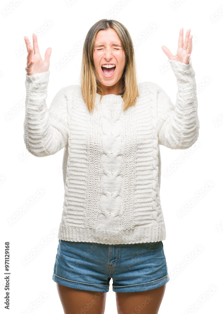 Young beautiful woman wearing winter sweater over isolated background celebrating mad and crazy for success with arms raised and closed eyes screaming excited. Winner concept