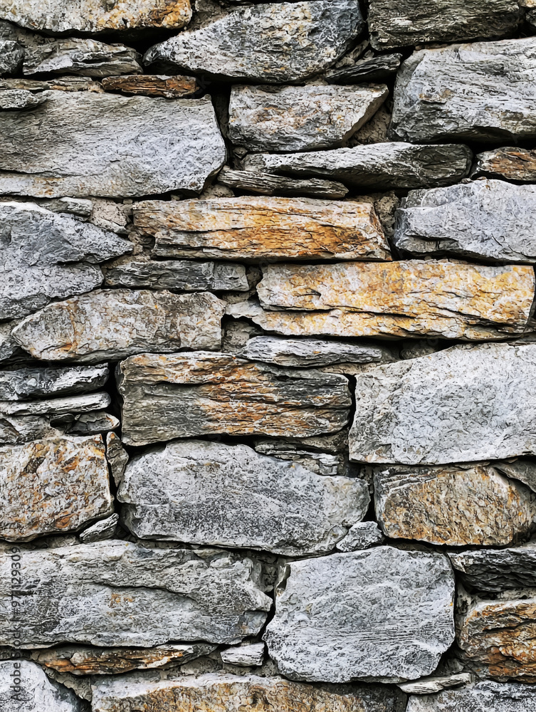 A wall made of stone with a few brown spots A wall made of stone with a few brown spots