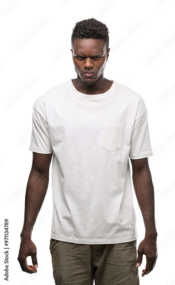 Fototapeta premium Young african american man wearing white t-shirt skeptic and nervous, frowning upset because of problem. Negative person.