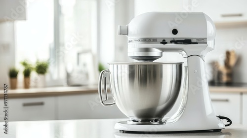 A white stand mixer with a stainless steel bowl on a kitchen countertop.