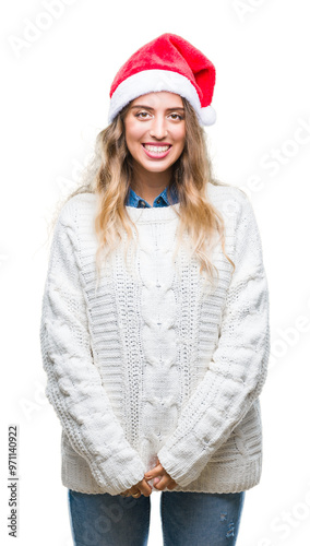 Beautiful young blonde woman wearing christmas hat over isolated background with a happy and cool smile on face. Lucky person.