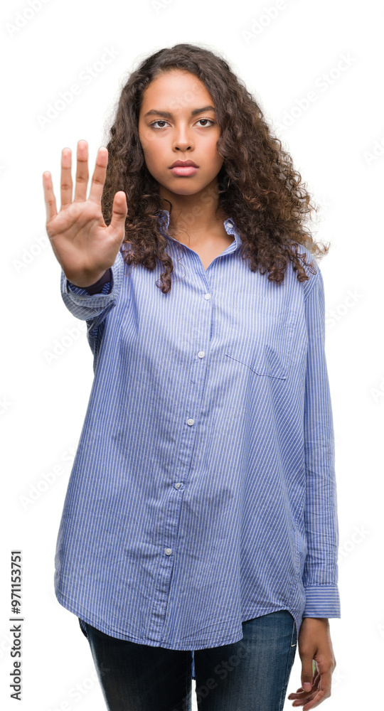 Young hispanic business woman doing stop sing with palm of the hand. Warning expression with negative and serious gesture on the face.