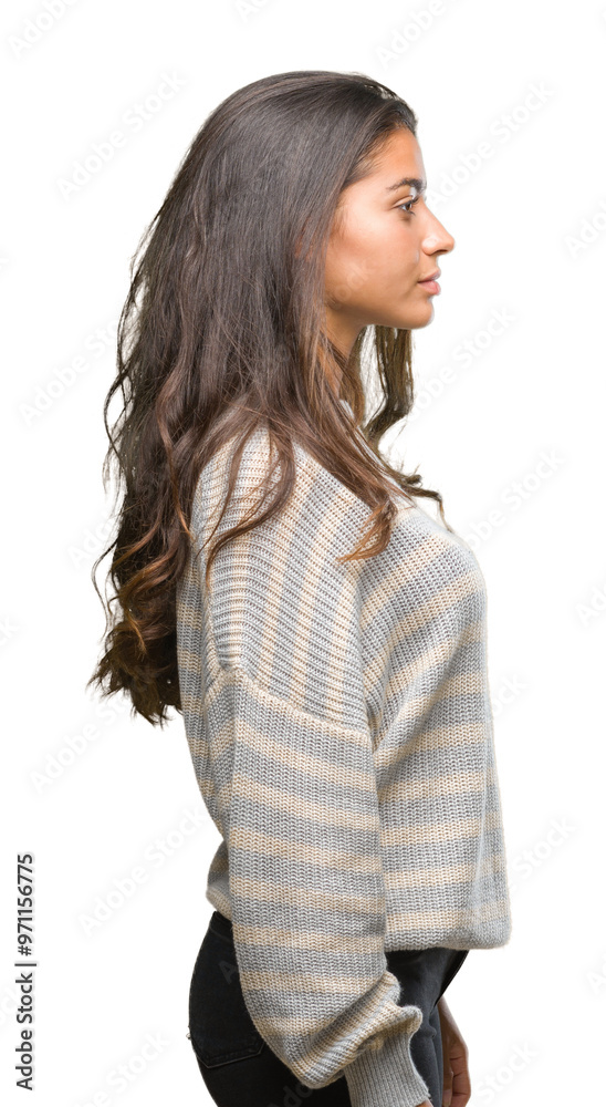 Young beautiful arab woman wearing winter sweater over isolated background looking to side, relax profile pose with natural face with confident smile. Young beautiful arab woman wearing winter sweater over isolated background looking to side, relax profile pose with natural face with confident smile.
