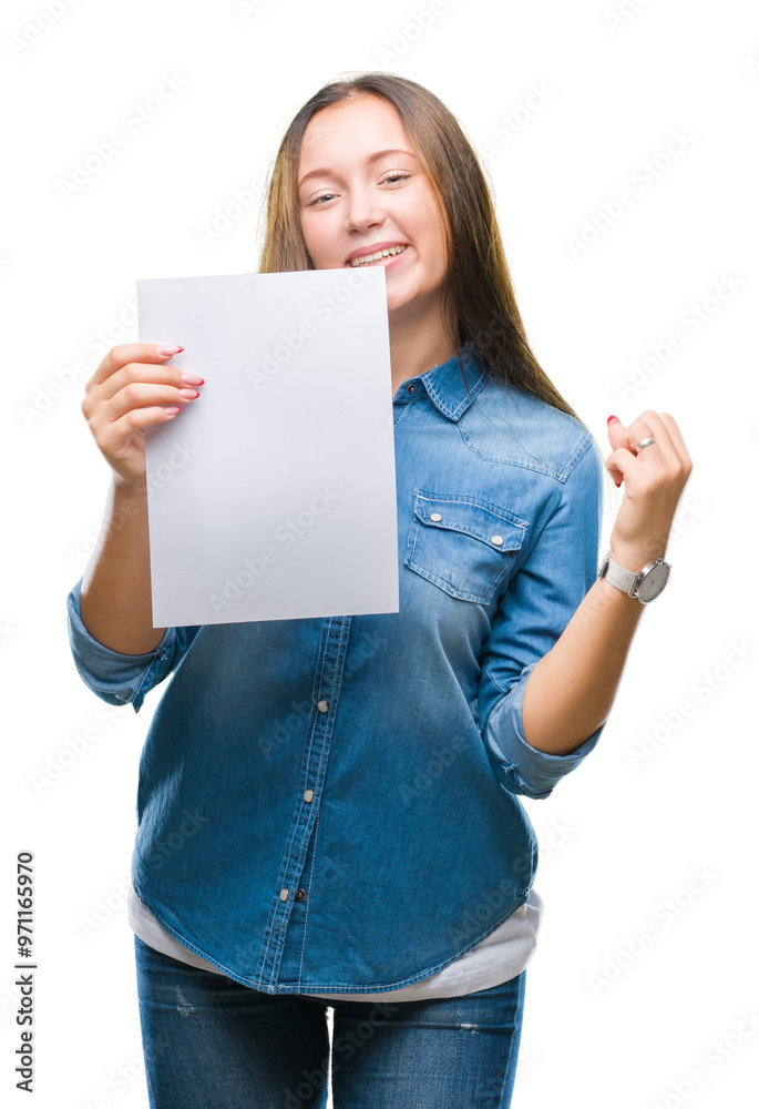 Young caucasian woman holding blank paper sheet over isolated background screaming proud and celebrating victory and success very excited, cheering emotion Young caucasian woman holding blank paper sheet over isolated background screaming proud and celebrating victory and success very excited, cheering emotion