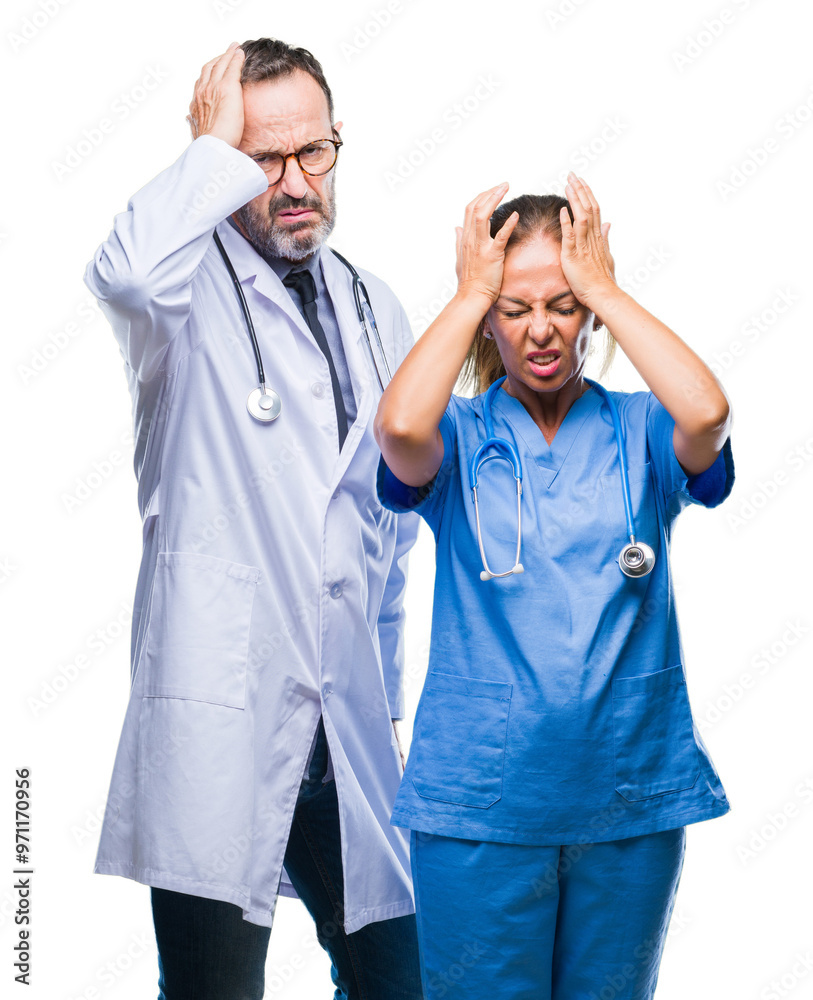 Φωτογραφία Middle age hispanic doctors partners couple wearing medical uniform over isolated background suffering from headache desperate and stressed because pain and migraine
