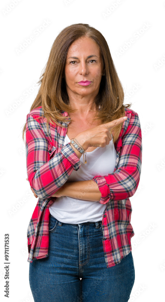 Beautiful middle age woman wearing over isolated background Pointing with hand finger to the side showing advertisement, serious and calm face Beautiful middle age woman wearing over isolated background Pointing with hand finger to the side showing advertisement, serious and calm face